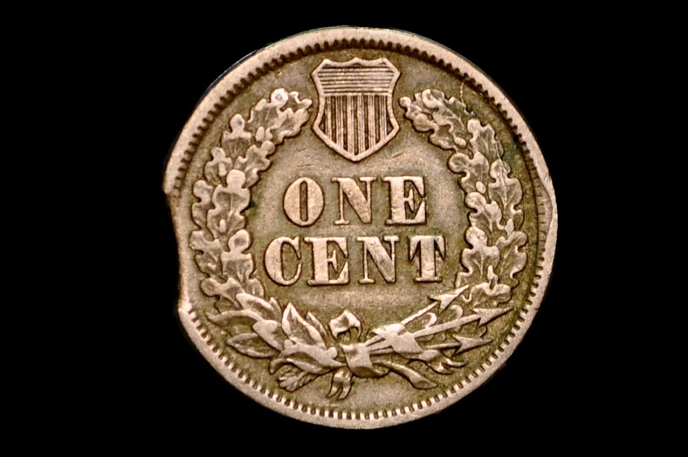 1886 Indian Head Penny clipped planchet error showing crescent-shaped missing section at the coin rim