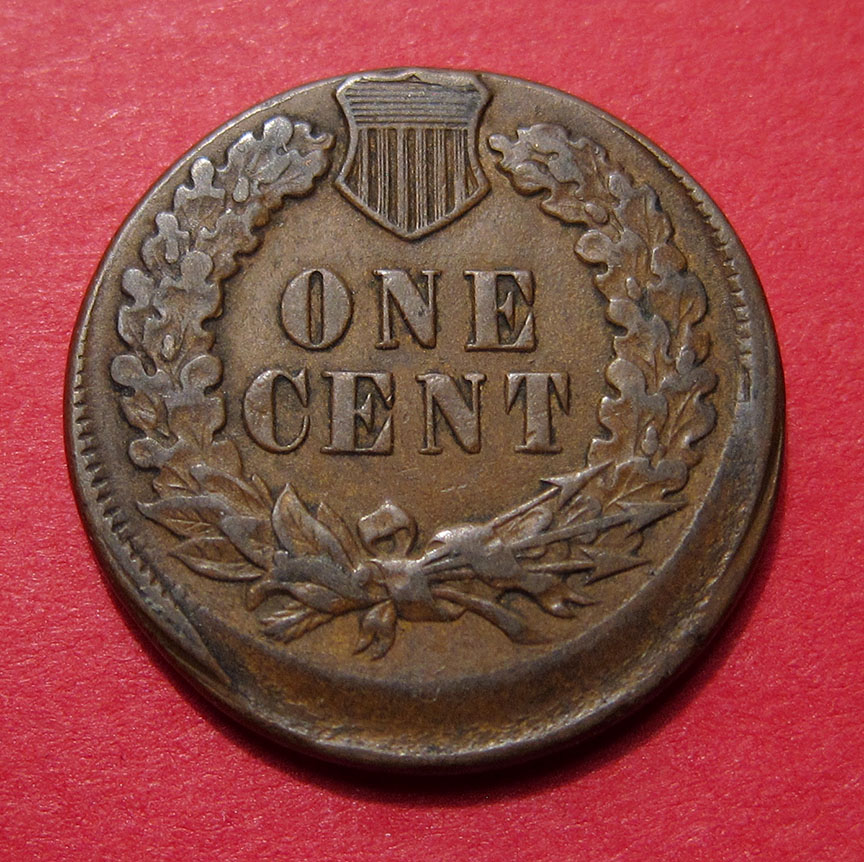 1886 Indian Head Penny off-center strike showing the design shifted with a blank planchet area visible